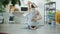 Back view of muscular young man stretching arms sitting on yoga mat exercising alone at home