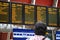 Back view of a passenger checking train timetable