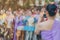 Back view of people take a photo by smartphone of a Thai dance parade in Songkran festival