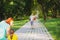 Back view photo of a mother and little girl waiting for her father to spend time with him being in the park and daddy