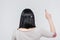 Back view portrait of a brunete girl pointing finger up