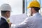 back view of professional architects in hard hats discussing