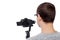 Back view of professional videographer shooting video with dslr camera on gimbal stabilizer isolated on white
