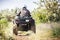 Back view of quad bike riding along a country road.