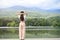 Back view, Relaxed Asian female looking at amazing beautiful mountain and lake view