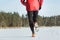 Back view of running sportsman during cross country race outdoor in winter forest