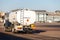 Back view small modern fuel tanker truck driving on airfield taxiway for aircraft refueling. Cistern lorry aviation