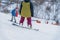 Back view of Snowboarder riding on Snowboard on ski slope. Active lifestyle, winter sport and recreation concept