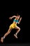 Back view. Sportive muscled woman, professional runner running away isolated on black background. Sport, fitness