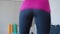 Back view of sportswoman running in place. Unrecognizable Caucasian sportive woman exercising indoors. Slim athletic