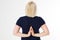 Back view of sporty woman standing in lotus pose isolated. Yoga and healthy lifestyle concept. hands closeup, middle-age woman