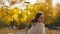 back view stunning young brunette woman joyfully running in autumn park with yellow foliage. happy attractive girl in