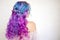 Back view of stylish youth girl with bright hair coloring, Ombre with blue purple shades.