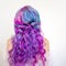 Back view of stylish youth girl with bright hair coloring, Ombre with blue purple shades.