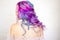 Back view of stylish youth girl with bright hair coloring, Ombre with blue purple shades.