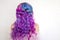 Back view of stylish youth girl with bright hair coloring, Ombre with blue purple shades.