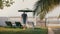 Back view successful male tourist slowly walks up to chairs and fence to enjoy epic summer ocean resort beach view.