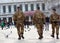 Back view of three anonymous men in military uniform