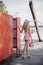 Back view to young blonde girl look like a Barbie doll in pink mini dress, pink bow with pink handbag coming out of changing room