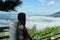 The back view of tourists sitting on the sea of â€‹â€‹mist on Khao Kho Mountain, Thailand.