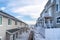 Back view of townhouses on a scenic suburban neighborhood on a snowy winter day