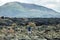Back view of traveler woman enjoy unique volcanic landscapes of