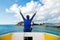 Back view of the traveler woman relaxing on the boat and looking at the Similan Andaman island, Thailand. Blue sky background.