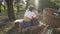 Back view of two cute women sitting together in the summer garden, their bicycles standing near. Beautiful lesbian