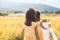 Back view of two little girls walking together in bamboo walkway