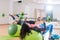 Back view of two women lifting barbell lying on stability ball while exercising in gym