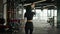 Back view unknown fit sportswoman girl athletic slim woman personal fitness trainer workout instructor walking in gym