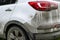 Back view of a very dirty car. Fragment of a dirty SUV. Dirty headlights, wheel and bumper of the off-road car with swamp splashes