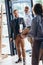 back view of waiter greeting handsome smiling businessmen