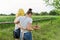 Back view on walking mother and teenage daughter hugging in together on farm