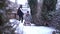 Back view wide shot of joyful teen girl stretching hands as man and woman pulling sled in slow motion smiling. Happy