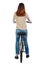 back view of a woman with a bicycle. cyclist sits on the bike
