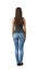 Back view of woman in gray sleeveless top and blue jeans standing with arms at sides isolated on white background.