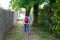 Back view of woman in pathway park path walking in Saint medard en jalles France