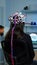 Back view of woman patient wearing performant eeg headset