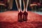 Back view woman\\\'s feet in elegant high heels at red carpet event
