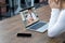 Back view of woman sit at desk at home have webcam conference on laptop computer with Orthopedic Surgeons about foot ankle bone