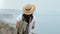 Back view woman in straw hat admiring beautiful natural seascape. Shot on RED Raven 4k Cinema Camera