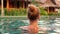 Back view of woman in swimming pool