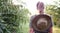 Back view of woman tracking and camping in forest, bluring background.