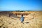 Back view of woman traveler in hat looking at amazing Amphitheater ruins in ancient Hierapolis, Pamukkale, Turkey. Grand panorama