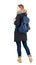 Back view woman in winter jacket with backpack