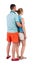 Back view of young embracing couple in shorts hug and look.