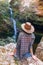 Back view of young girl in straw hat and looking at waterfall. Caucasian young lady looks at falling water, photo on