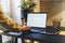 Back view. Young male millennial sits in an office at a table and works on a laptop, mail, social networks. View a computer screen