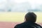 Back View of Young Man on Bleachers